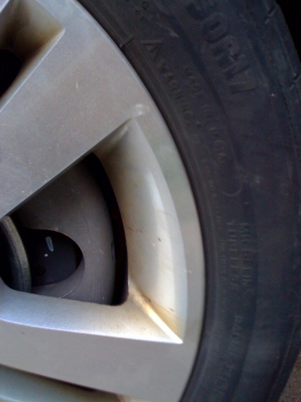 Close-up of silver alloy wheel with Michelin tire