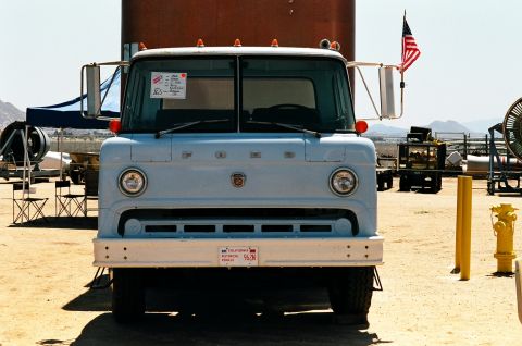 1981 Kenworth W900A - A light blue truck is parked outdoors, displaying a California historical vehicle plate on its bumper.