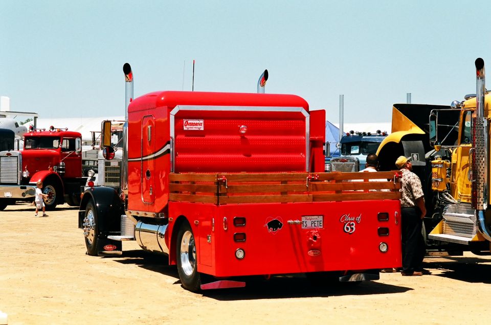 Red flatbed truck with wooden sides, "Class of 63" decal, and "MS PETE" license plate