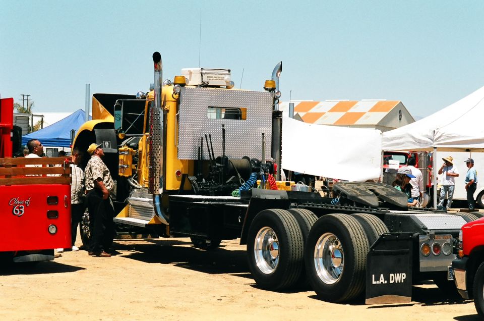 1981 Kenworth W900A semi-truck cab and chassis with dual rear wheels and chrome stacks. L.A. DWP mudflap visible