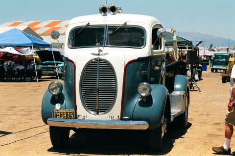 1981 Kenworth W900A - A vintage two-tone truck is parked outdoors, with other vehicles and tents visible in the background.