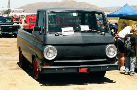 1981 Kenworth W900A - This black pickup truck with red wheels and a NOS license plate is on display at an outdoor event.