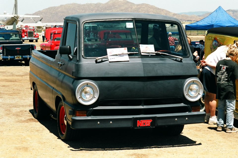 Black pickup truck with red wheels and a NOS license plate
