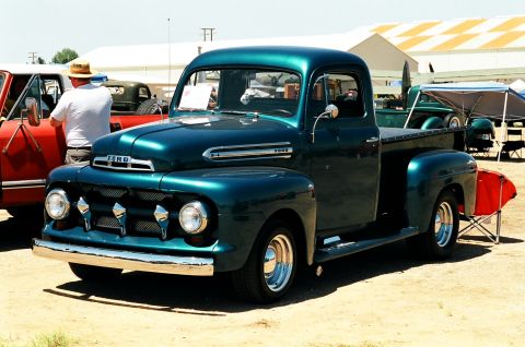 1981 Kenworth W900A - A teal 1951 Ford F-series pickup truck is displayed at an outdoor event.