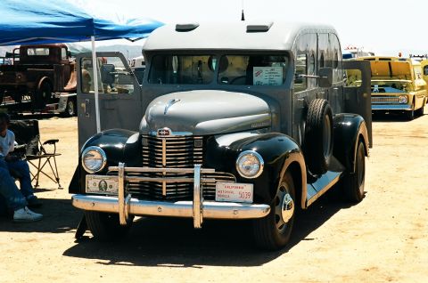 1981 Kenworth W900A - A vintage truck with a distinctive grille and two-tone paint is displayed at an outdoor event.