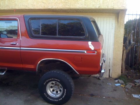 1978 Ford Bronco - This 1978 Ford Bronco is seen from the side, its distinctive red paint and black hardtop.