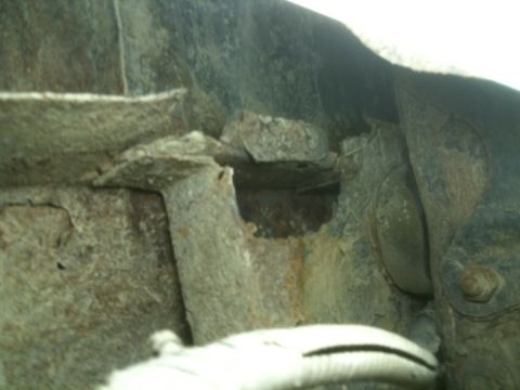 1993 Ford Bronco - The vehicle's frame shows significant rust and deterioration, obscuring any identifying details.