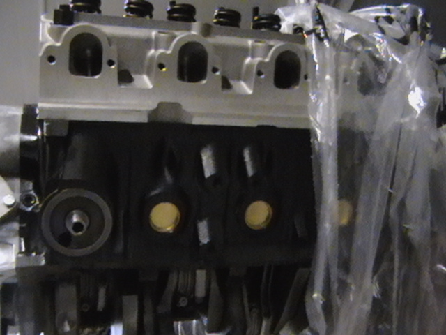 Bare engine block and cylinder head partly wrapped in plastic