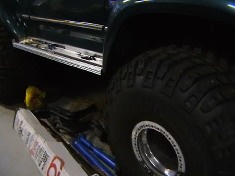 1996 Ford Bronco - Side view of a 1996 Ford Bronco with a large off-road tire and running board.