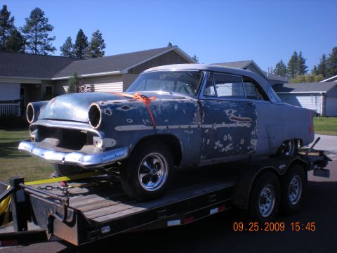 1974 Ford Ranchero - This 1954 Ford Fairlane Victoria is being transported on a trailer, likely for restoration work.