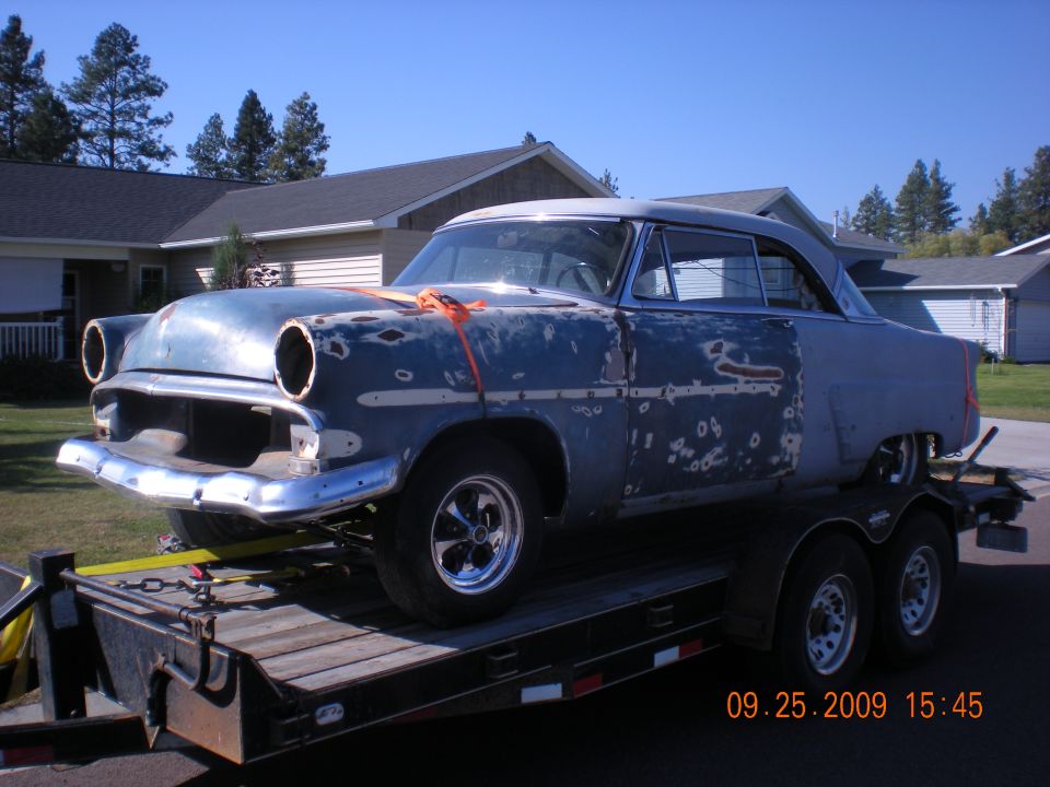 1954 Ford Fairlane Victoria on a trailer, undergoing restoration. Missing headlights and grille