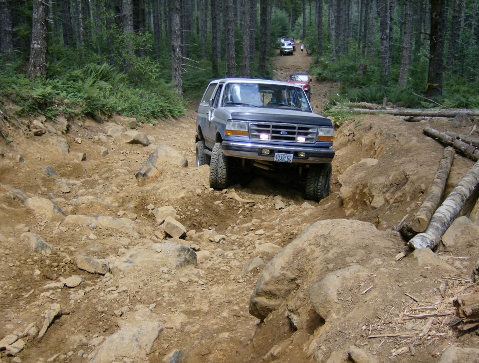 1996 Ford Bronco on a rocky forest trail
