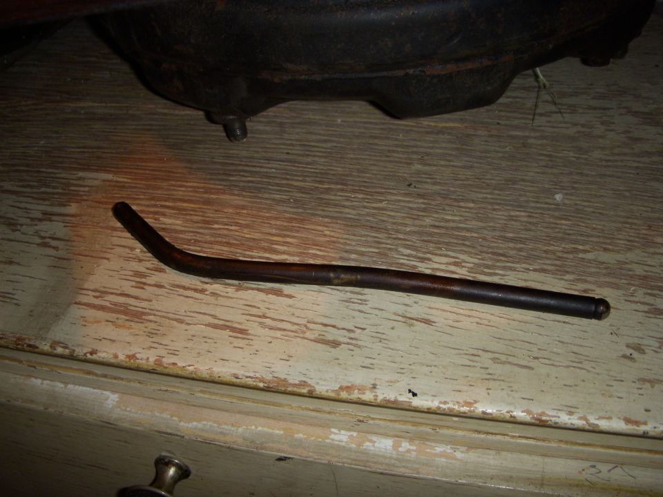 Bent metal rod on a wooden surface