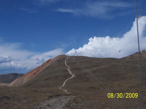 1994 Ford Bronco - Vehicles navigate a steep dirt road on a mountain pass on 08/30/2009.
