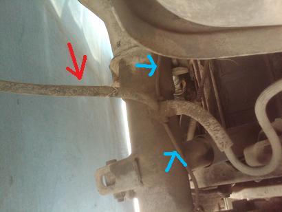 1982 Ford Bronco - Close-up view of vehicle undercarriage components, highlighted by red and blue arrows, with Supermotors.net branding at the bottom.