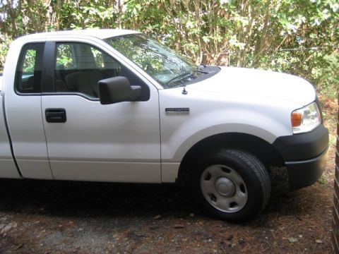 2004 Ford F-150 - A white Ford F-150 pickup truck is shown from the front driver's side, parked in an outdoor setting.