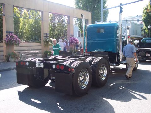 1981 Kenworth W900A - A teal semi-truck chassis is seen from the rear, with a license plate reading C-59019.