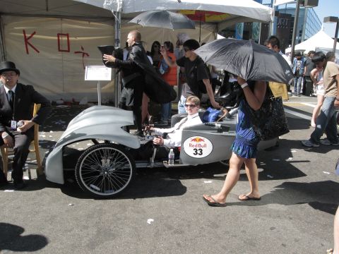 1986 Ford Bronco - A custom-built vehicle with a Red Bull sponsorship logo is being driven by a participant at an outdoor event.