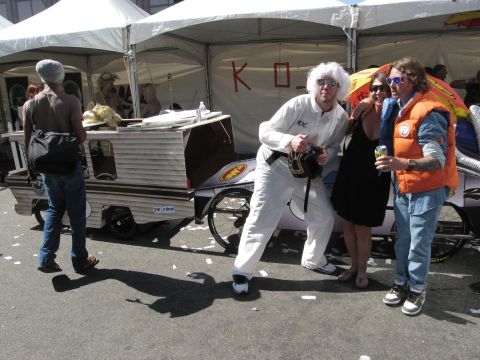 1986 Ford Bronco - A group poses with a custom-built trailer, possibly a prop from a themed event.