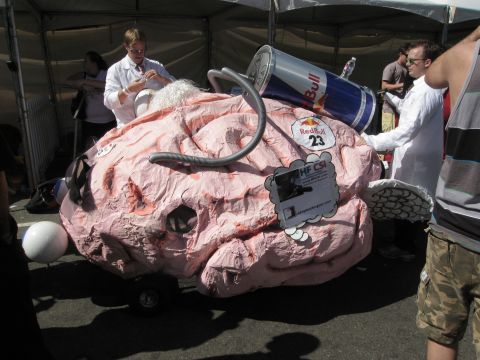 1986 Ford Bronco - A creative float resembling a brain, complete with a Red Bull can and a sign reading 'HF CSI', at an event.