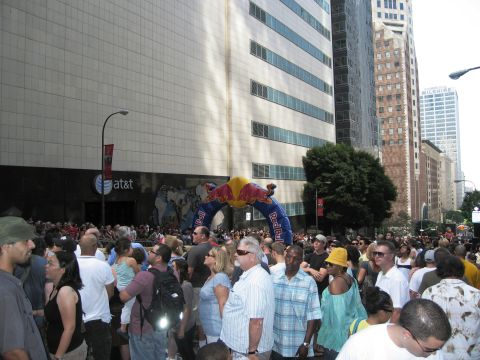 1986 Ford Bronco - A large crowd gathers under a Red Bull archway during an event in a city with tall buildings.