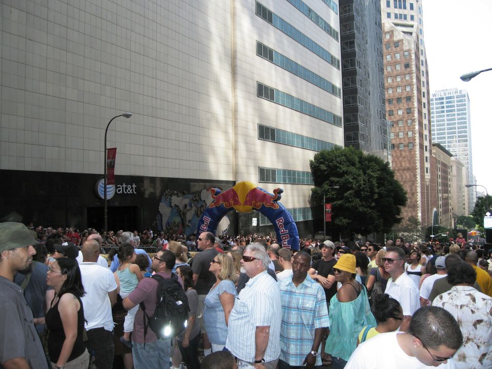 Crowd gathered under Red Bull archway in city