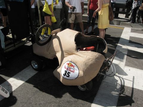 1986 Ford Bronco - A custom-built soap box derby car with a Red Bull sponsorship is prepared for an event.