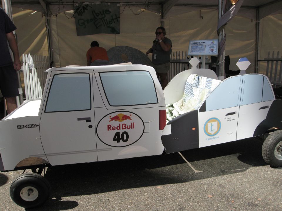 White soapbox car with Red Bull logo and 'Bronco' text, resembling a modified SUV and police car