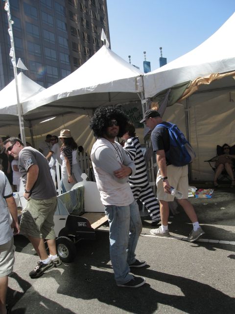 1986 Ford Bronco - Attendees gather under tents at an outdoor event, with some people in costumes and others in everyday attire.