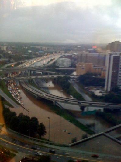 1979 Ford F-150 - A flooded highway causes traffic jams and submerged vehicles in an urban area during heavy rainfall.