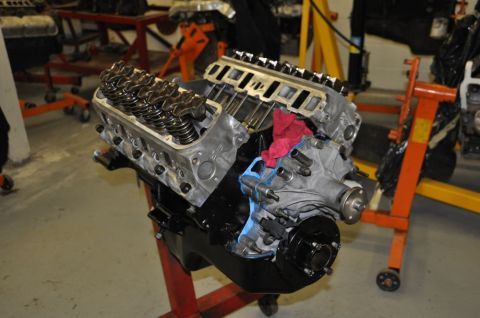 1996 Ford Bronco - A V8 engine block is shown on an engine stand, with its valve covers removed.