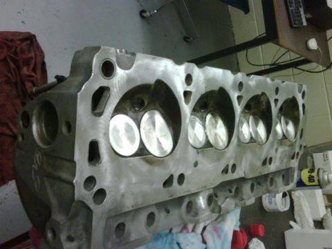 1996 Ford Bronco - Close-up of an engine cylinder head, showing multiple valves and ports.