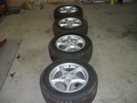 2002 Chevrolet Camaro - Four tires and wheels are shown on a concrete floor. ABS text is visible on one wheel.