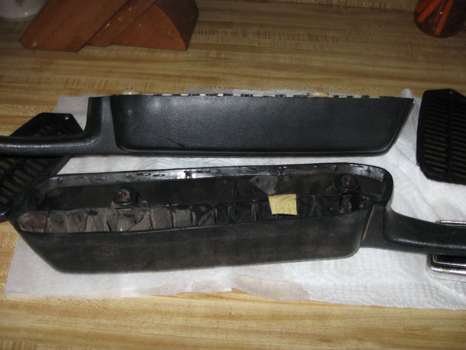 Two black interior door panels, one disassembled