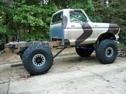 1979 Ford F-150 - This modified 1979 Ford F-150 pickup truck is shown with its chassis and large tires, ready for off-road use.