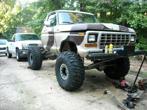 1979 Ford F-150 - A heavily modified 1979 Ford F-150 truck is parked outside with another truck in the background.