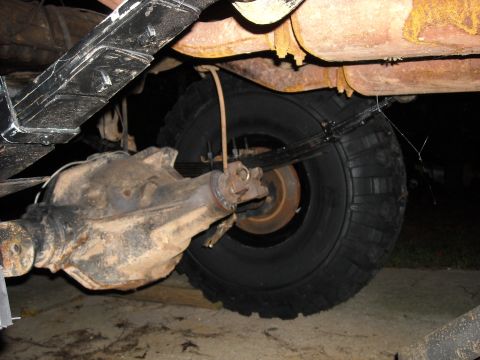 1979 Ford F-150 - Close-up view of a vehicle's rear axle, leaf springs, and exhaust system components.