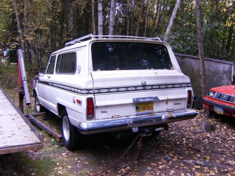 2000 Ford E350 - Rear view of a white 1974 Jeep Cherokee Chief, parked outdoors with a red car nearby.