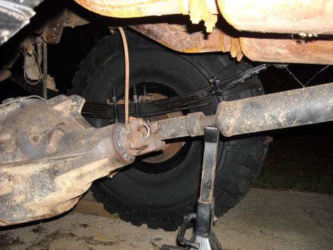1979 Ford F-150 - Undercarriage view showing the rear axle assembly, leaf springs, and driveshaft of a vehicle.