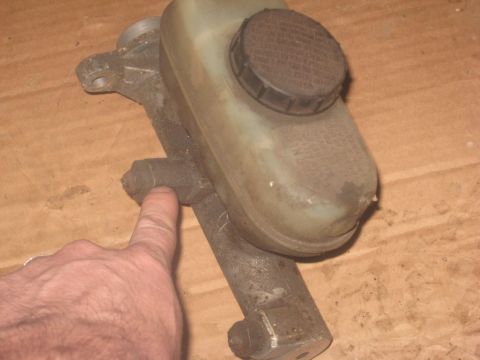 1995 Ford Bronco - Close-up of a brake master cylinder assembly, likely for a vehicle repair or restoration project.