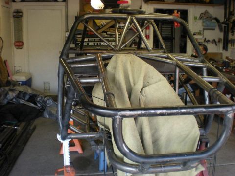 Suzuki Samurai - A custom tube chassis is being worked on in a garage environment.