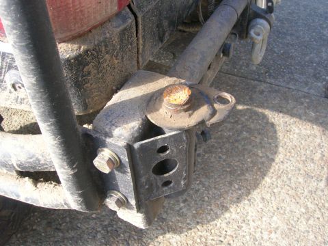 1996 Ford Bronco - Close-up view of a vehicle's rear bumper mount and tow hitch receiver assembly.