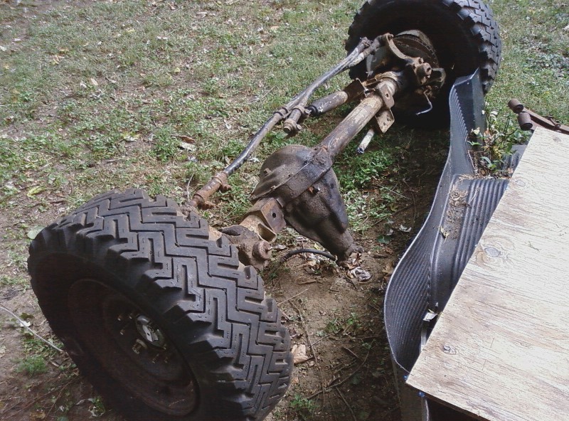 Front axle assembly with tire, removed from vehicle