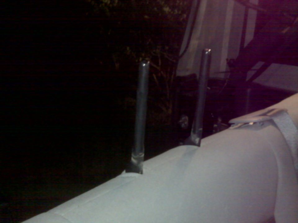 Headrest posts emerging from a white seat cover