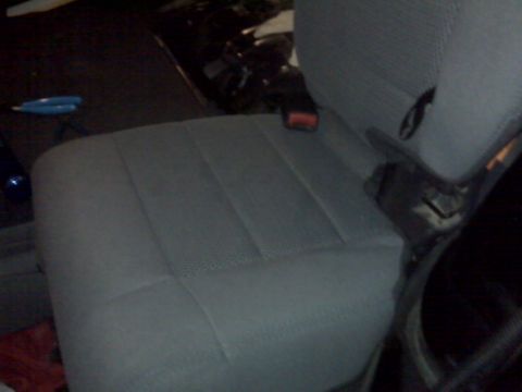 2008 Jeep Wrangler - Interior view of a gray fabric seat with a visible seatbelt buckle.