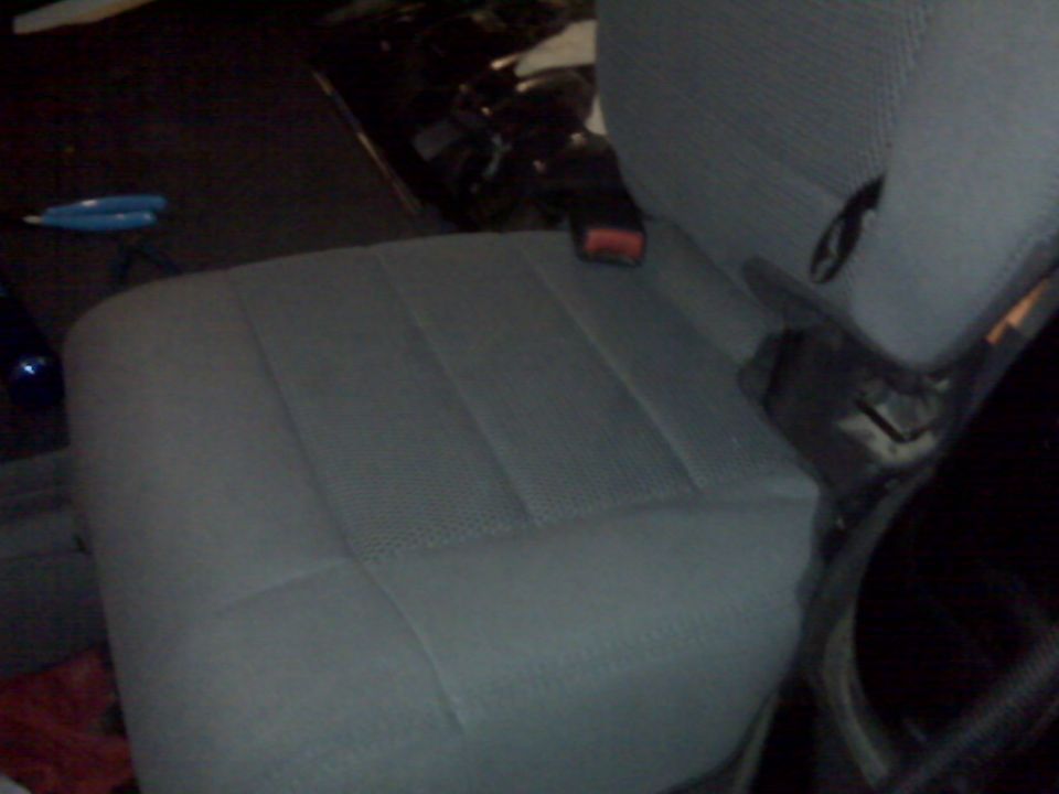 Gray fabric seat interior with seatbelt visible