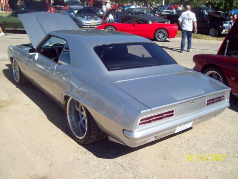 1995 Ford Probe - A silver 1969 Chevrolet Camaro coupe is displayed with its hood open at an outdoor car show.
