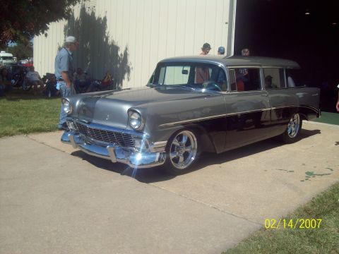 1995 Ford Probe - A classic two-tone Chevrolet Nomad wagon is displayed outdoors with people in the background.