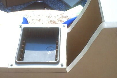 1999 Ford Taurus - A close-up view of an empty tray cutout, possibly from a vehicle's interior, with some blue material peeking out.