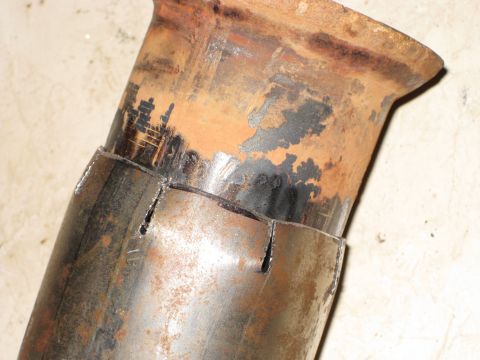 1995 Ford Bronco - This image shows a section of a rusty exhaust pipe that has been cut in preparation for a Y-pipe modification.
